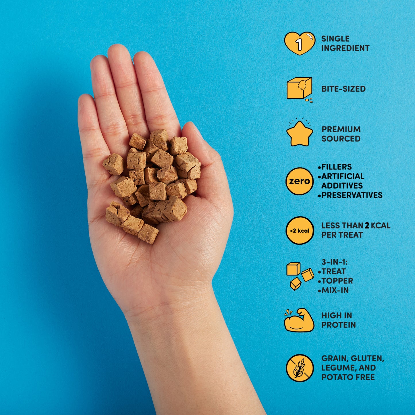 Freeze dried duck liver treat in hand with product benefits: single ingredient, bite-sized, premium sourced, zero fillers, artificial additives, or preservatives, less than 2 kcal per treat, 3-in-1 treat/topper/mix in, high in protein, & grain, gluten, legume and potato free.