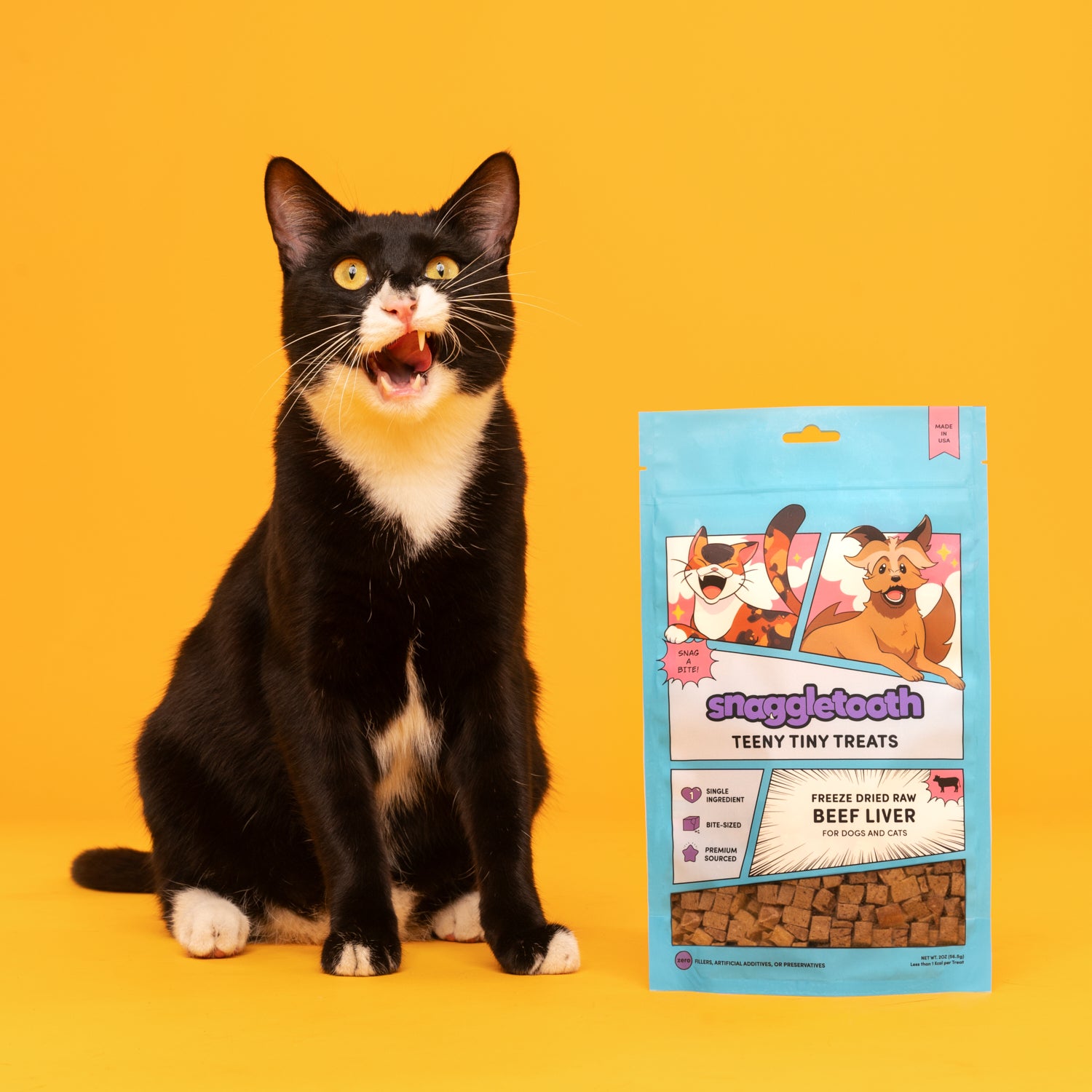 a bag of snaggletooth freeze dried beef liver treats next to a tuxedo cat